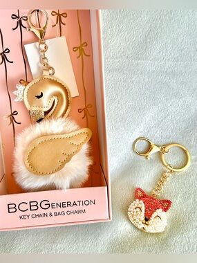 Gold Swan Pom Key Charm and Orange & White Cat Pendant Key Chain Duo